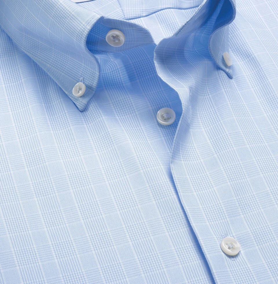 Close-up view of accurate collar stitching and clean button layout execution on a premium woven dress shirt